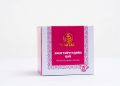 A box of Dr. Baatar's menstrual cramps relief tea against a plain white background. The packaging is primarily pink and white with decorative patterns and text in different languages.