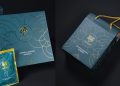 Elegant packaging featuring dark teal gift boxes with intricate gold designs and a lion logo. Includes a gift bag with rope handles and green product sachets, all showcasing consistent branding.